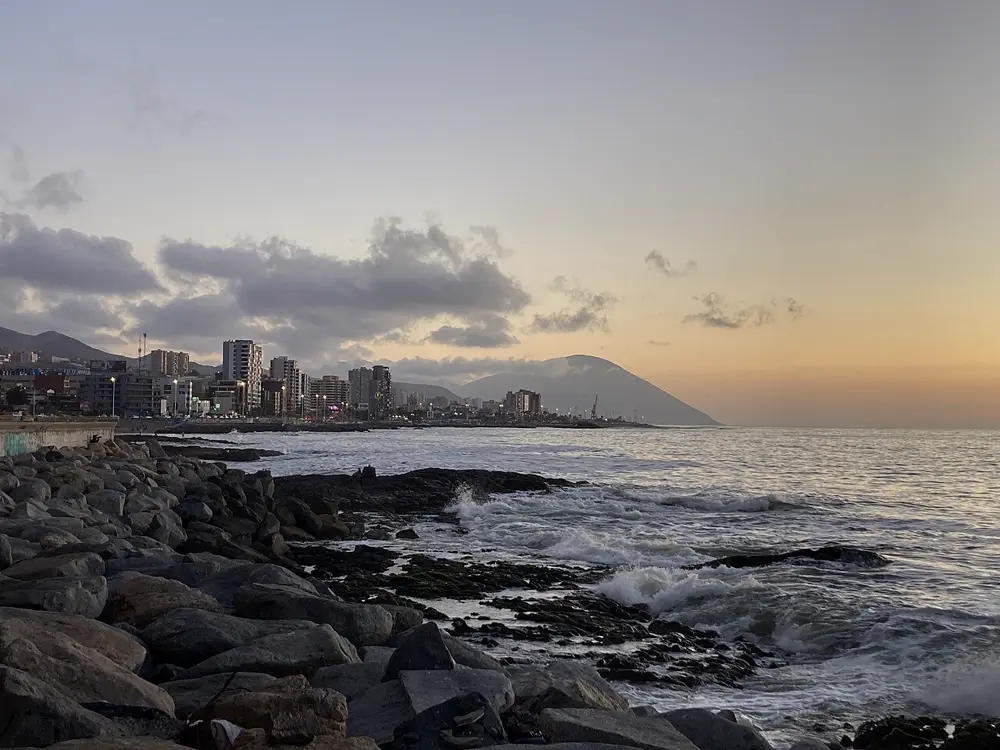 Costanera de Antofagasta al atardecer con el mar y los cerros, paisaje del norte que retrata el periodista y filmmaker en Instagram Chile